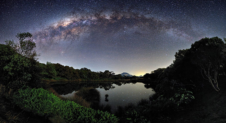 Twenty Photographs: The Milky Way arches over a mirror-like lake on the island of Réunion