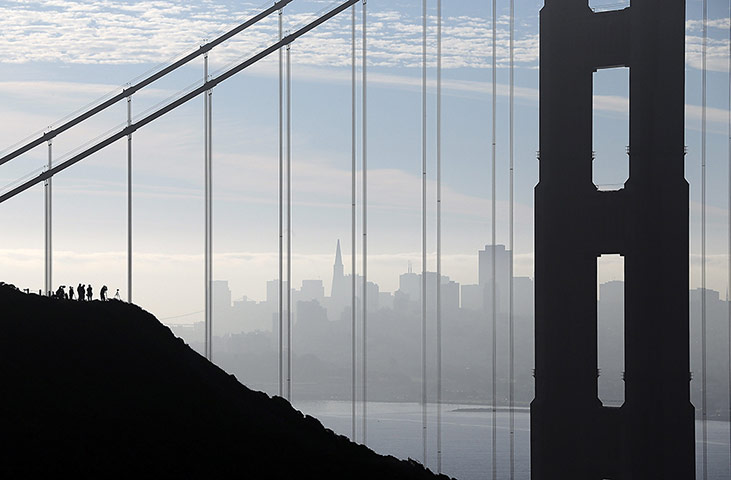 Twenty Photographs: Spectators wait by the Golden Gate bridge in San Francisco to see space shuttle Endeavour pass by