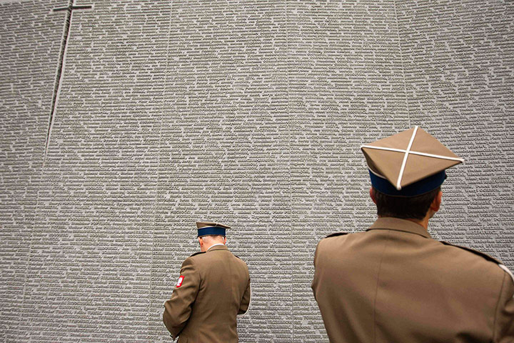 24 Hours: Polish soldiers beside a wall in Kiev, Ukraine, bearing names of victims of the Katyn massacre
