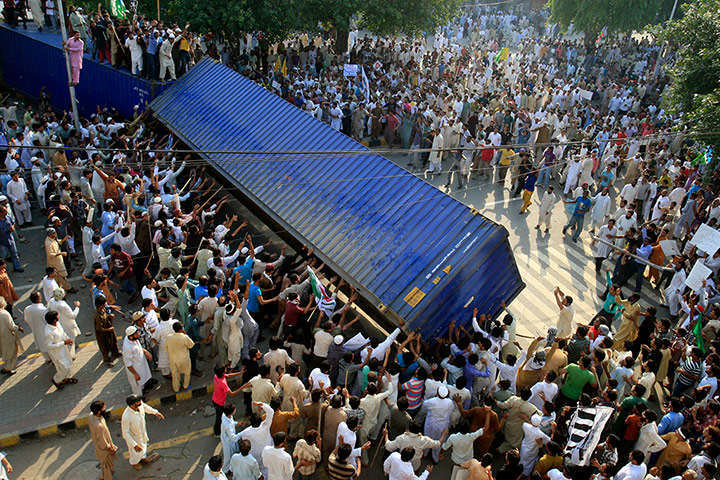 24 Hours: Protesters in Lahore, Pakistan, topple a shipping container blocking the road