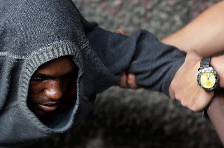 24 Hours: A suspected crack user is led away by a municipal agent in Rio de Janeiro, Brazil