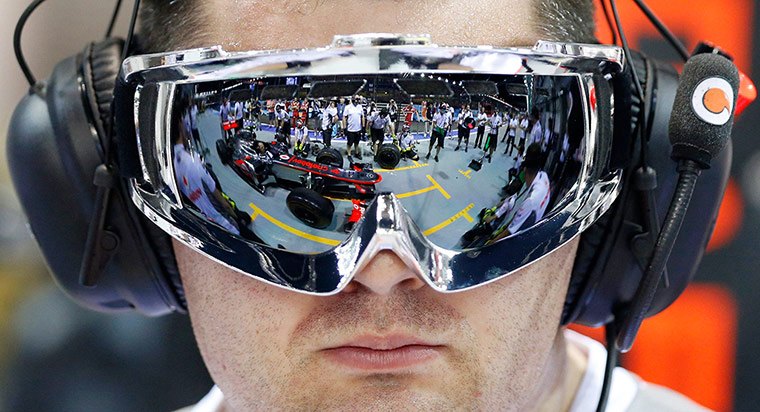 Best of week: A McLare team member observes as pit crew practice changing tyres