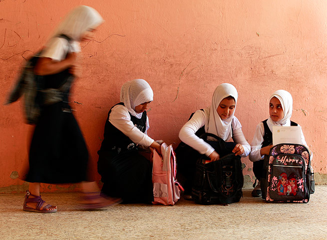 24 hours: Baghdad, Iraq: School children walk out of their classroom in Sadr City