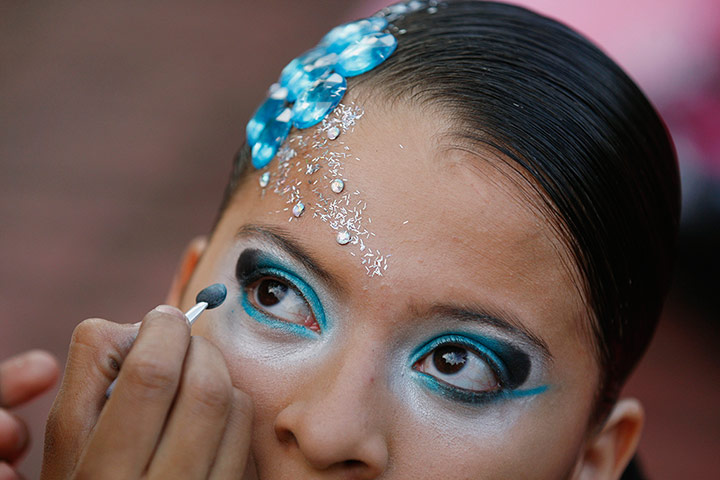 24 hours: Cali, Colombia: A dancer prepares to participate in World Salsa Festival