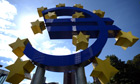 A giant euro logo stands in front of the headquarters of the European Central Bank