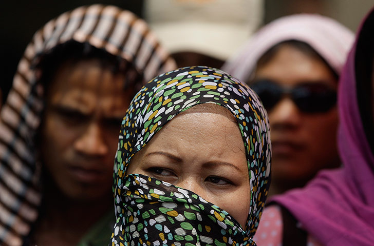 24 hours: Manila, Philippines: A Muslim woman listens during a rally