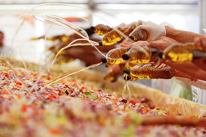 24 hours: Bucharest, Romania: Volunteers add olive oil to the world's biggest salad