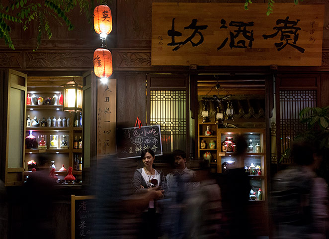 24 hours: Chengdu, China: A woman waits for customers
