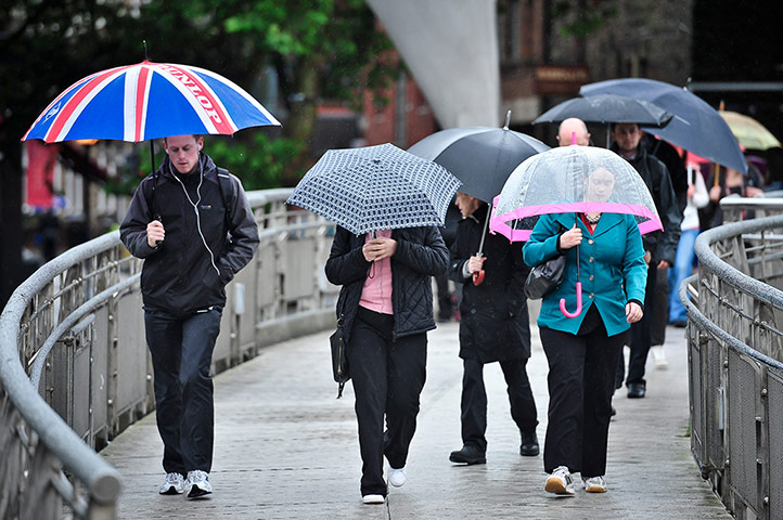 Rainy weather: Commuters with umbrellas