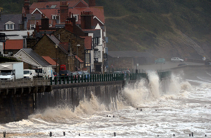 Rainy weather: Gale force winds drive waves over the coastal road near Whitby