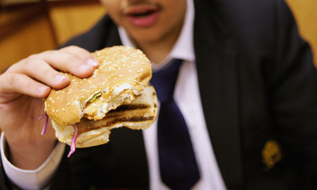 Teenager eating a burger