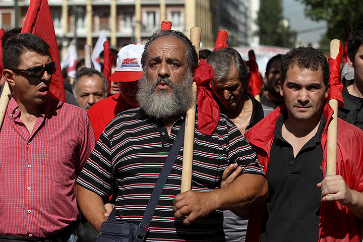 Greece protests: Workers shout slogans during a general strike protest