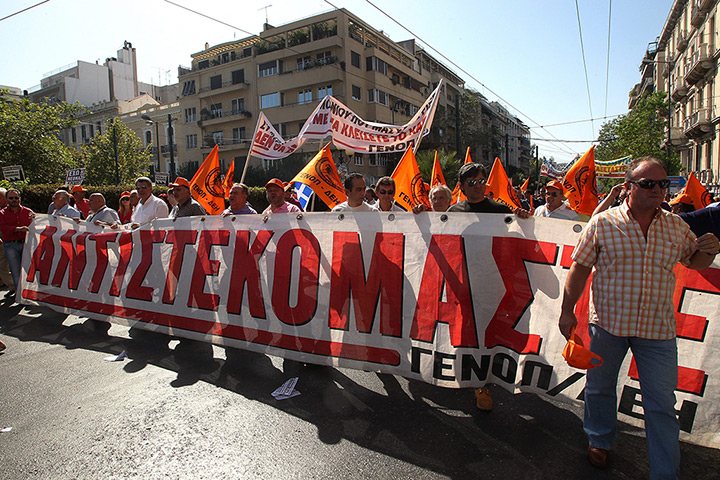Greece protests: Workers hold a banner that reads 'resist' during a general strike