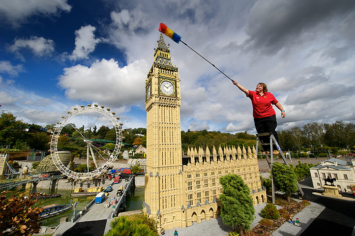 Legoland gallery: Model maker Paula Laughton reaches out to dust the tip of the model Big Ben