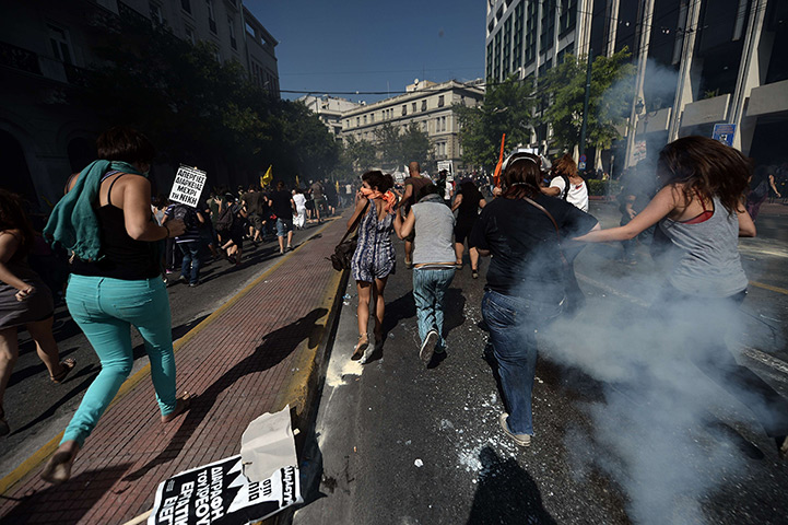 Greece protests updates: Demonstrators run away from teargas shot by riot police