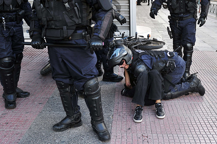 Greece protests updates: Police arrest a demonstrator on the ground