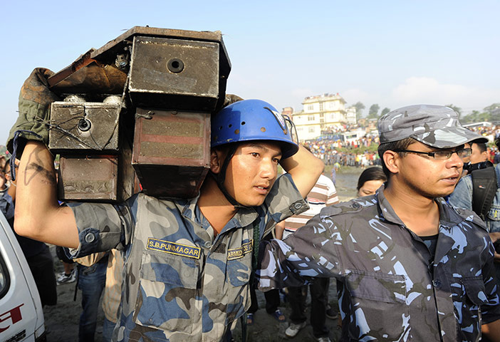 Nepal plane crash: A Nepalese police man carries the black box