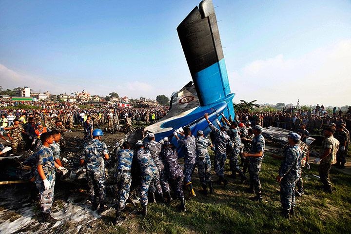 Nepal plane crash: Nepalese police search move the remains of a Sita Air plane