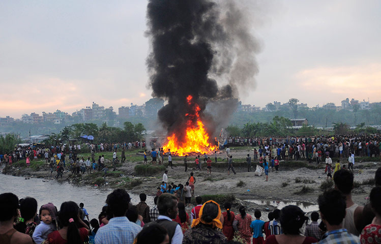 Nepal plane crash: People gather around the burning wreckage