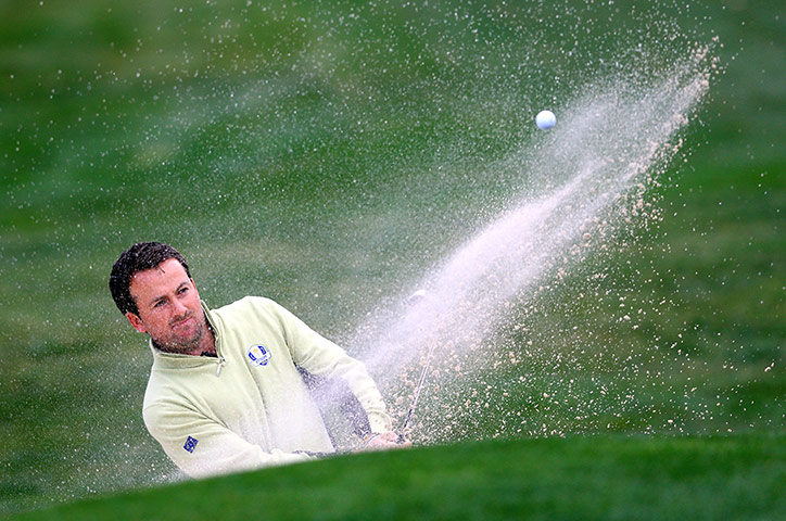 Ryder Cup day 1: Graeme McDowell hits his second shot out of the bunker on the eighth hole