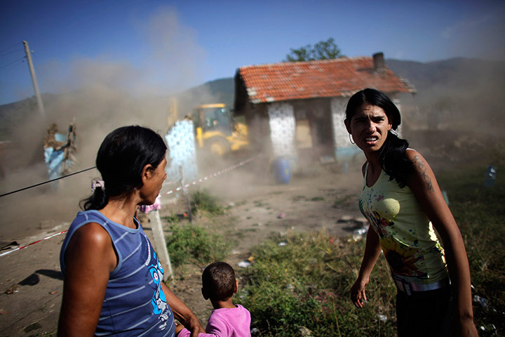 Twenty Photos: Bulgarian Roma women react as an excavator demolishes their house