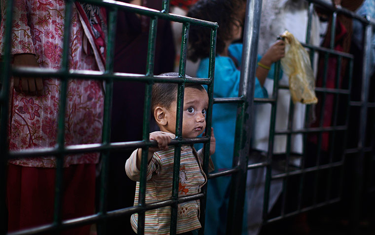 24 hours: A Pakistani child waits her turn to receive a ration of donated rice