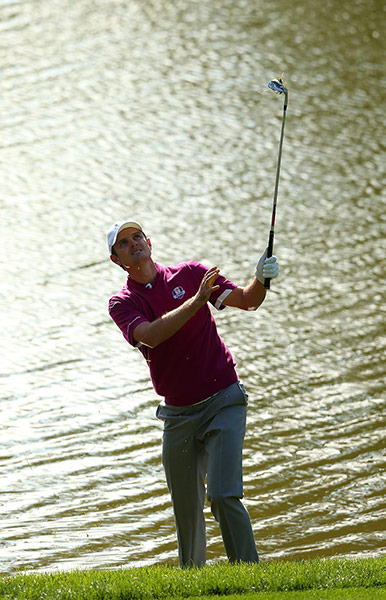 Ryder Cup day 2: Justin Rose watches a shot from the waters edge on the 15th
