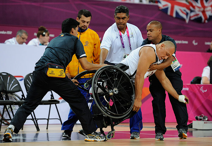 TJ basketball: Canadian Richard Peter is helped back up by the Colombin coaching staff