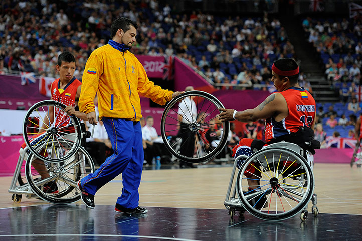TJ basketball: Colombian Miguel Chaparro gets a new wheel from a mechanic.