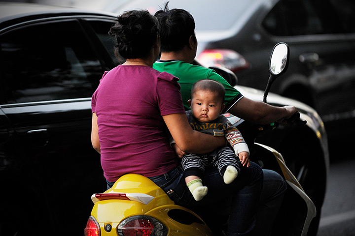 24 hours: Beijing, China: family rides electric bike