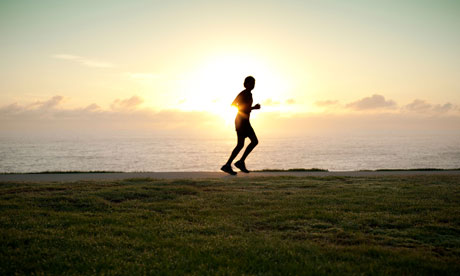 Jogger running alone with sun on horizon. Image shot 2010. Exact date unknown.