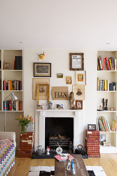 Space: Homes Feature: Wall of living room with collection or assorted pictures over the fireplace