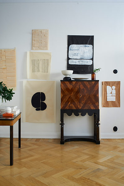 Space: Homes Feature: White wall with cabinet and art works on the wall