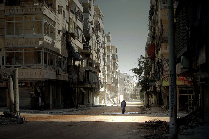 24 hours in pictures: A man walks through the Salaheddin neighbourhood of Aleppo