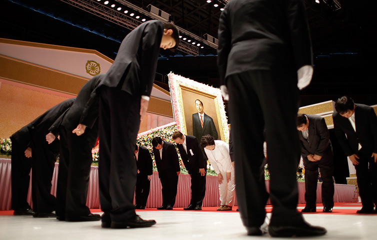 24 hours in pictures: Moonies bow in front of a portrait of the late Reverend Sun Myung Moon