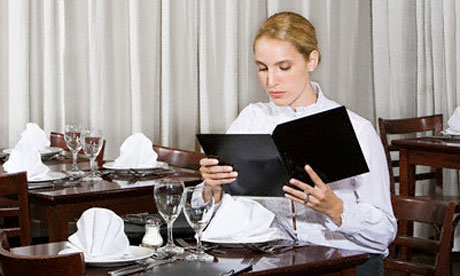 Woman looking at menu in restaurant