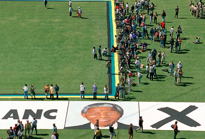 Apartheid gallery: Portrait of Nelson Mandela is on the grass at Soweto football stadium