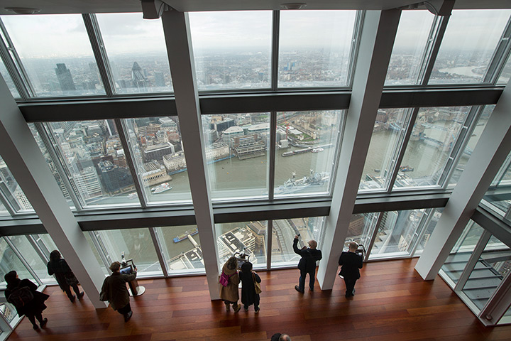 Shard view: Visitors look out at the mist-obscured view of London from the 68th floor