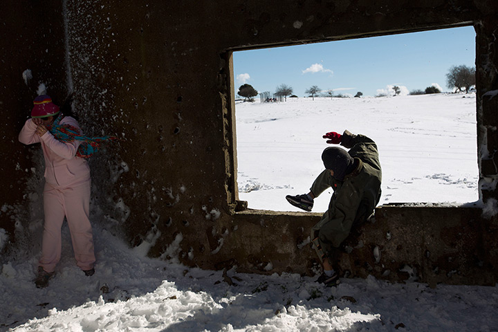 24 hours in pictures: Children play in an abandoned building at a snow 