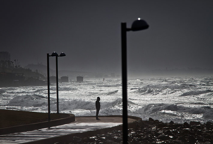 20 Photos: A person looks at waves