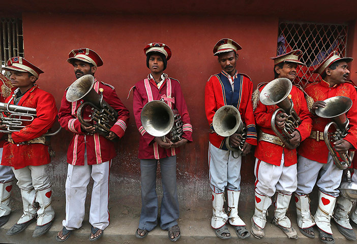 24 hours: Members of a brass band wait for a religious procession to start
