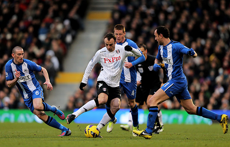 sat round up : Dimitar Berbatov takes on the Wigan defence