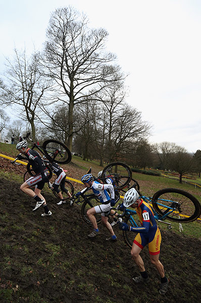Cyclo-cross: Competitors run up a hill as they take part in the 'Veteran 40-49 Men' race