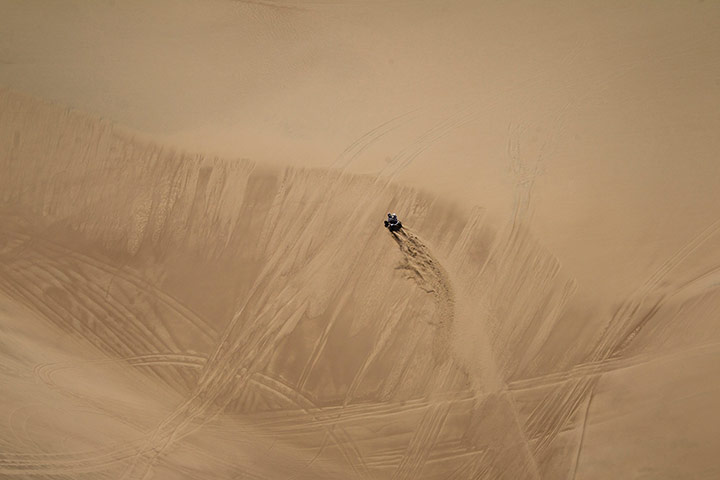 Dakar 2013: Enrique Okumura rides his quad bike across a dune