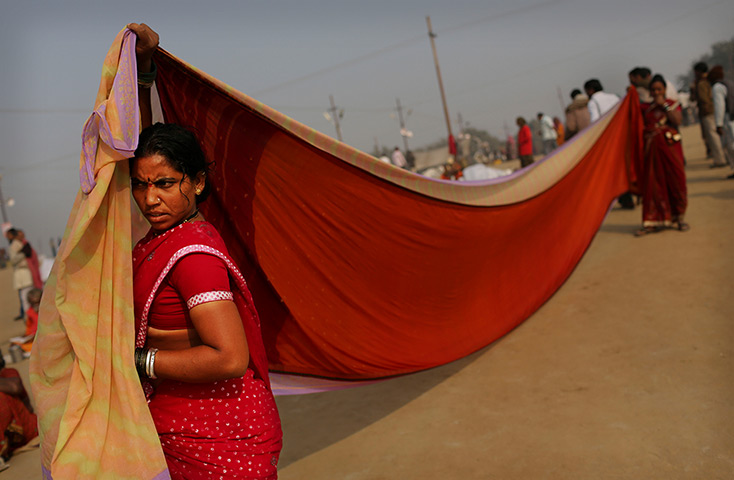24 hours in pictures: Indian Hindu women dry saris