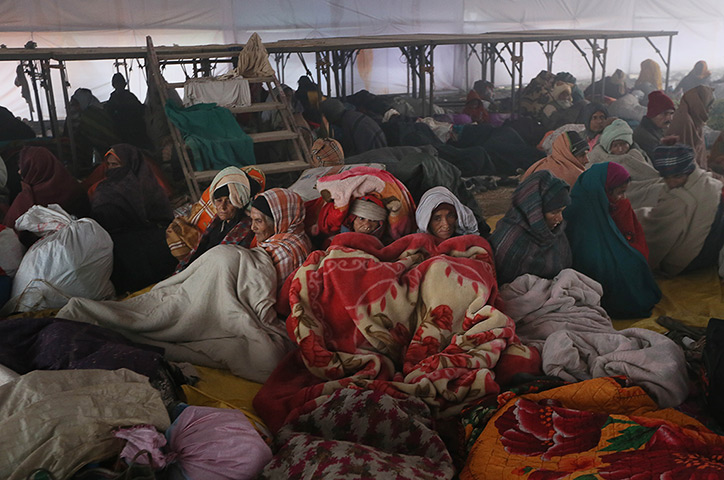 24 hours in pictures: Hindu devotees wrapped themselves in blankets to beat the cold