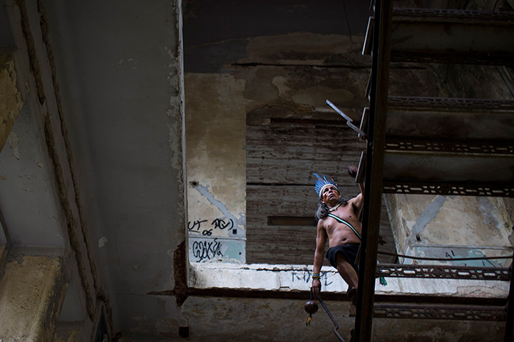 24 hours in pictures: An indigenous man ascends a stairway to the rooftop of an old Indian museum