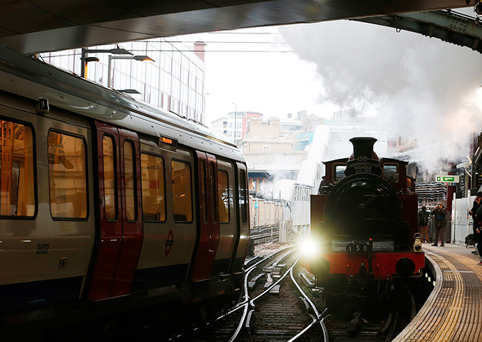 Met locomotive: A steam train passes a tube train as it enters Farringdon Station