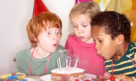 children blowing candles out