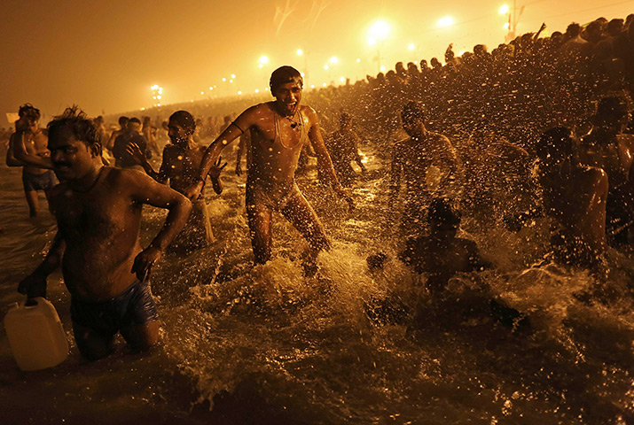 Kumbh Mela: An Indian Hindu man jumps up and down in the water at Sangam